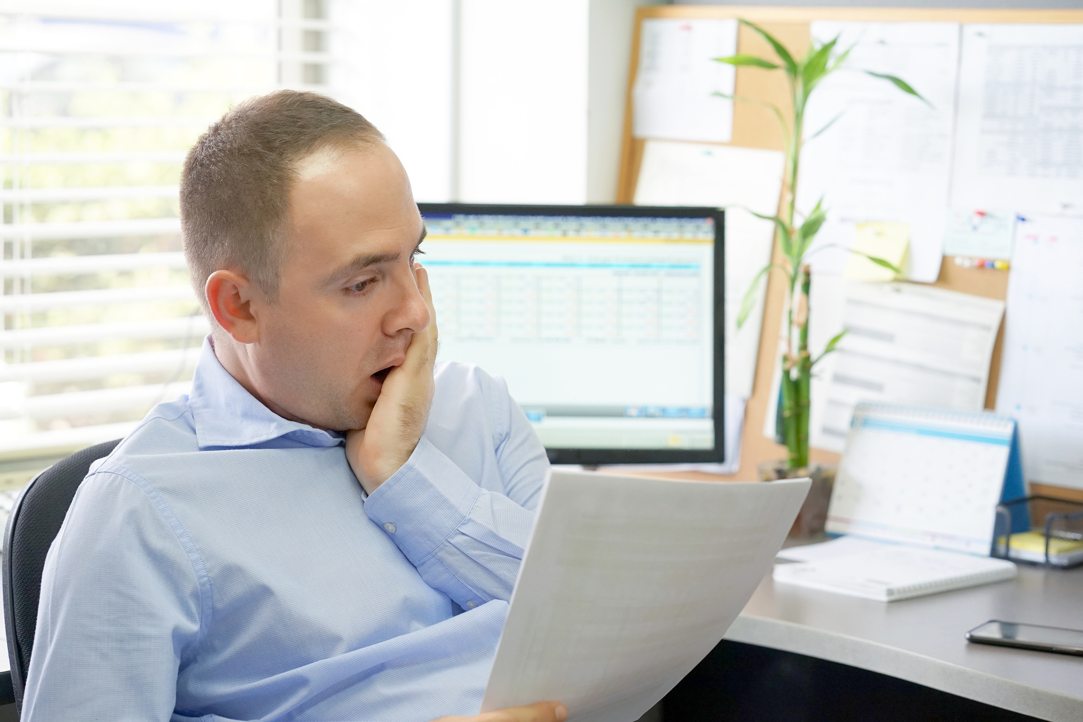 business man reading a document in office workspace